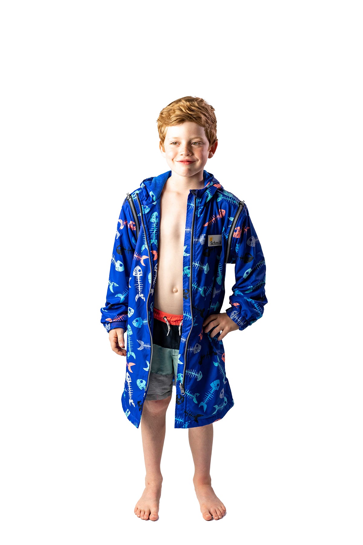 Boy wearing size 10 Schmik fishbone swim parka, Swim parka has remobable sleeves and a fishbone pattern. Swim parka comes with pockets and has a fitted hood.