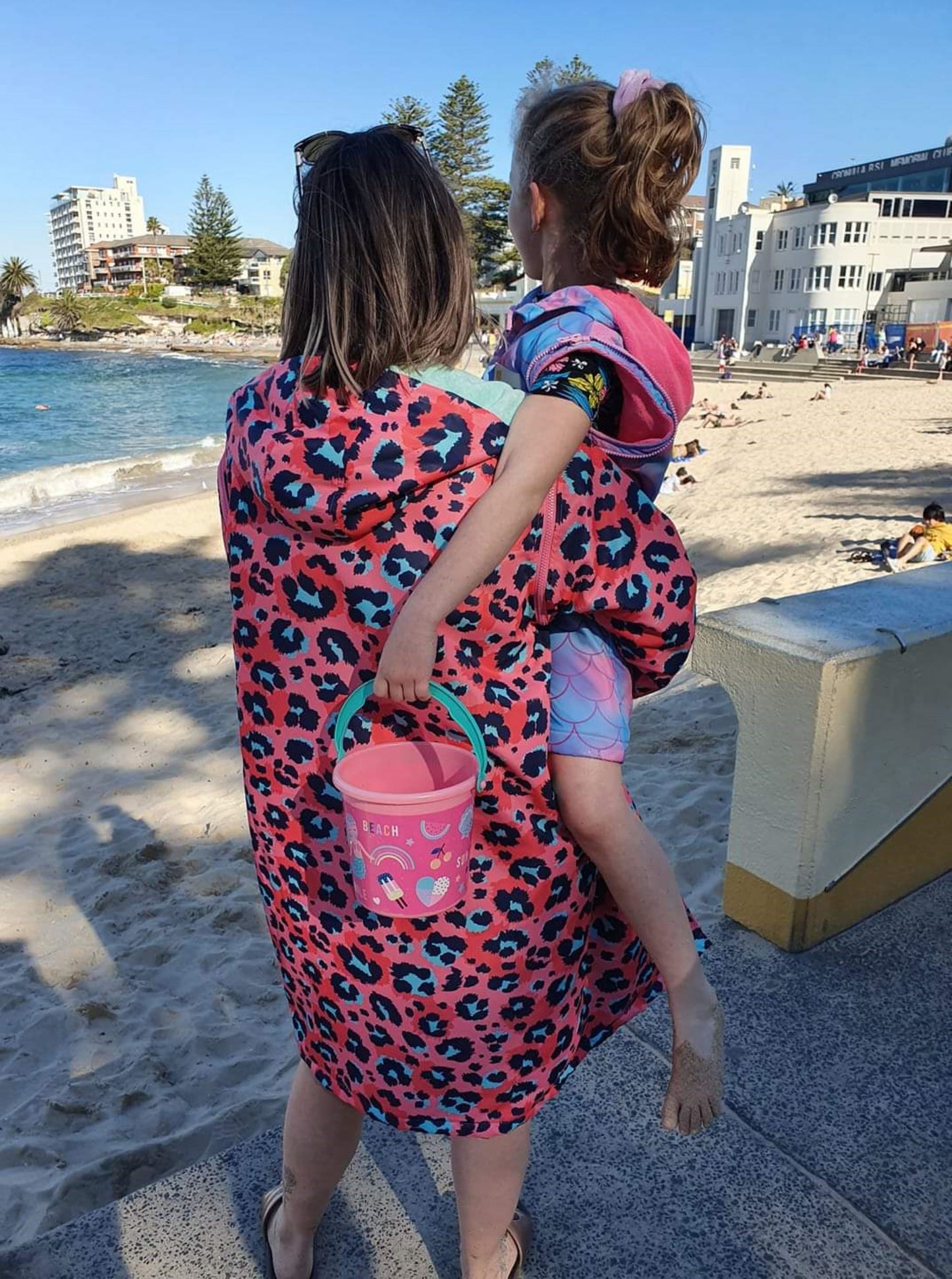 Schmik kids and adult swim parka. Adult animal print swim parka and kids mermaid print swim parka. Cronulla Beach.