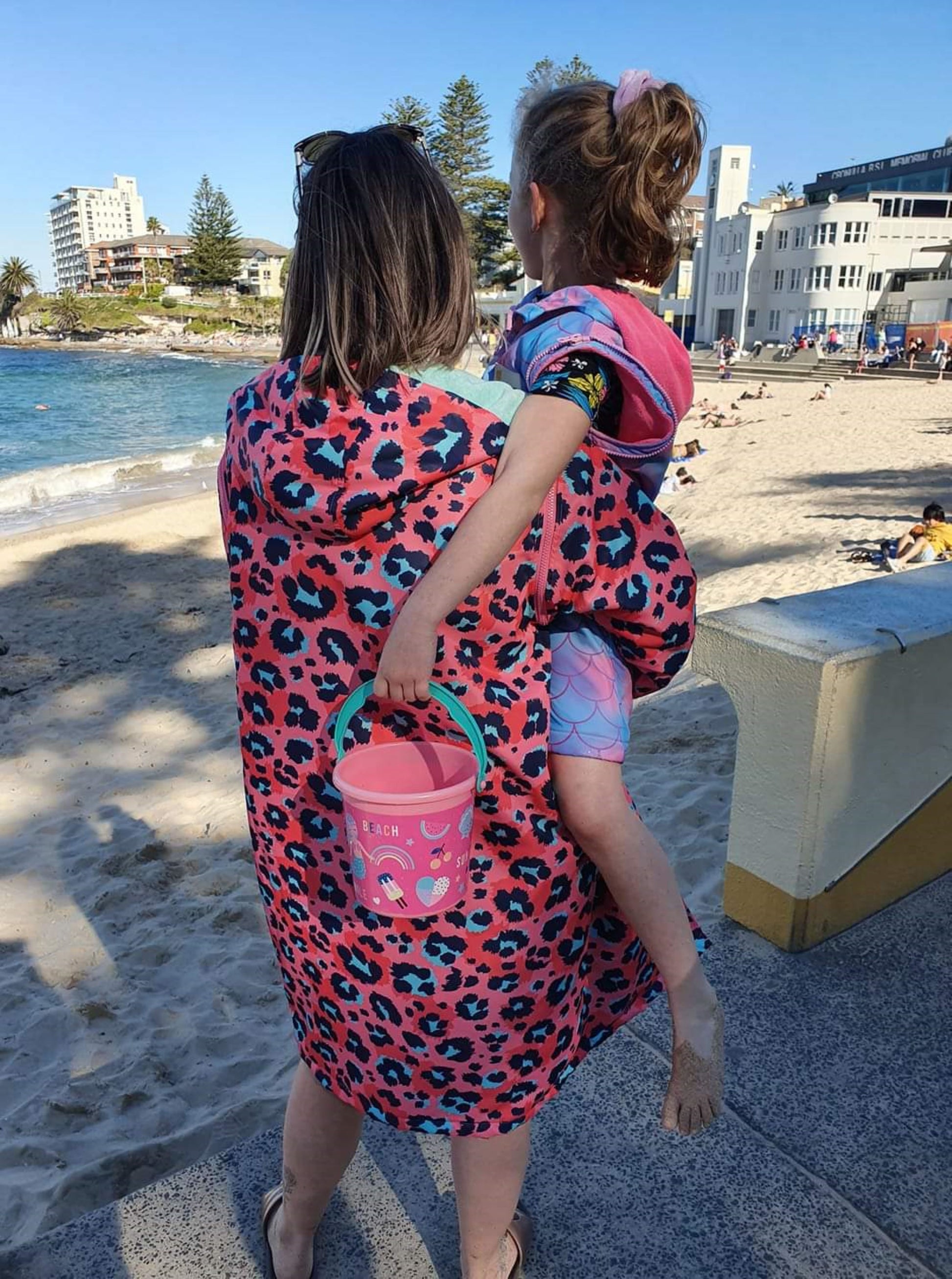 Schmik kids and adult swim parka. Adult animal print swim parka and kids mermaid print swim parka. Cronulla Beach.