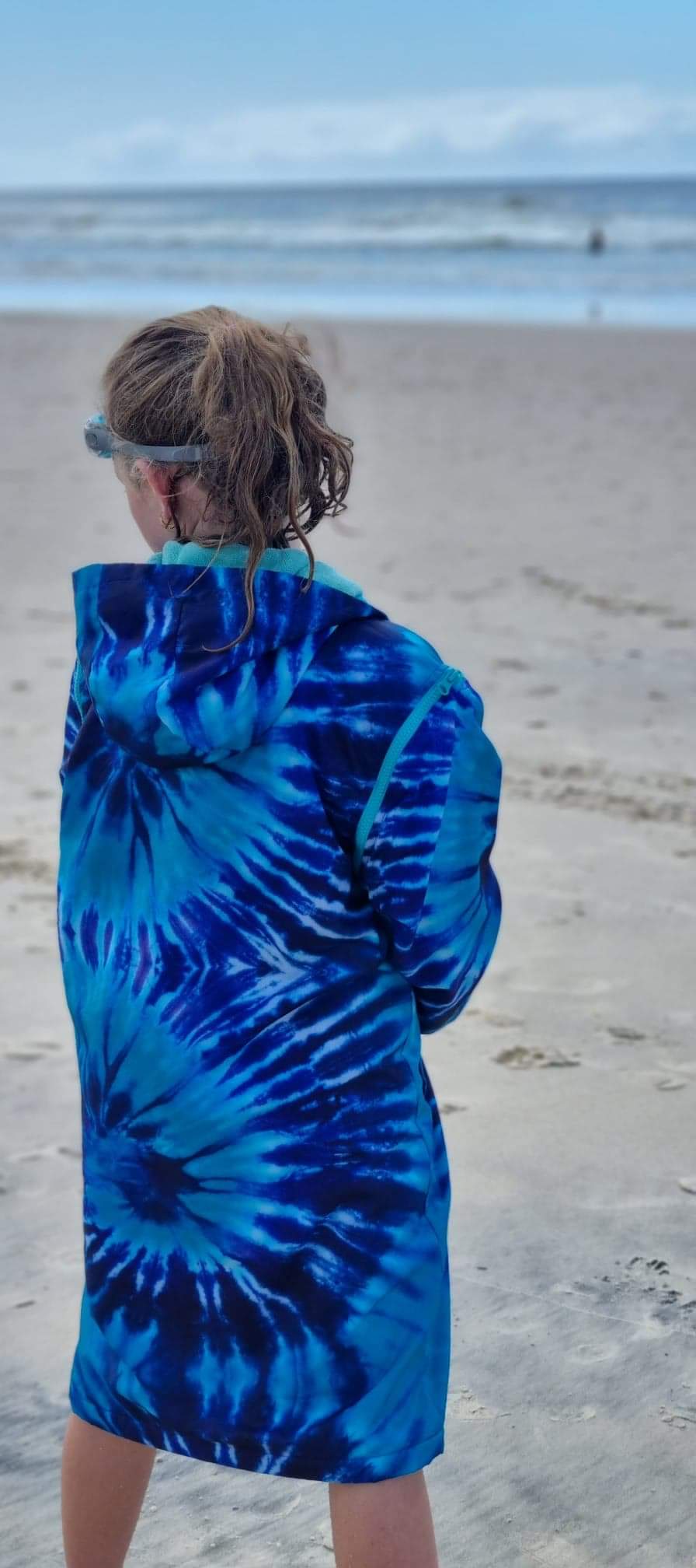 After swim jacket for beach. Girl wrapped in a schmik parka at the beach.