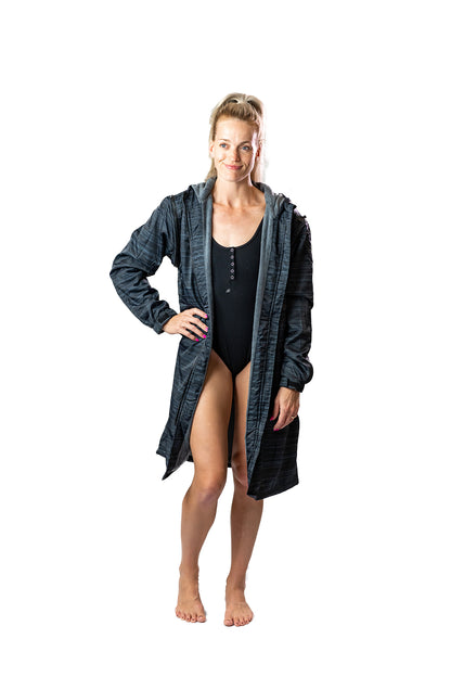 Adult female wearing speedo swimmers and wearing a schmik black swim parka. Black swim parka.