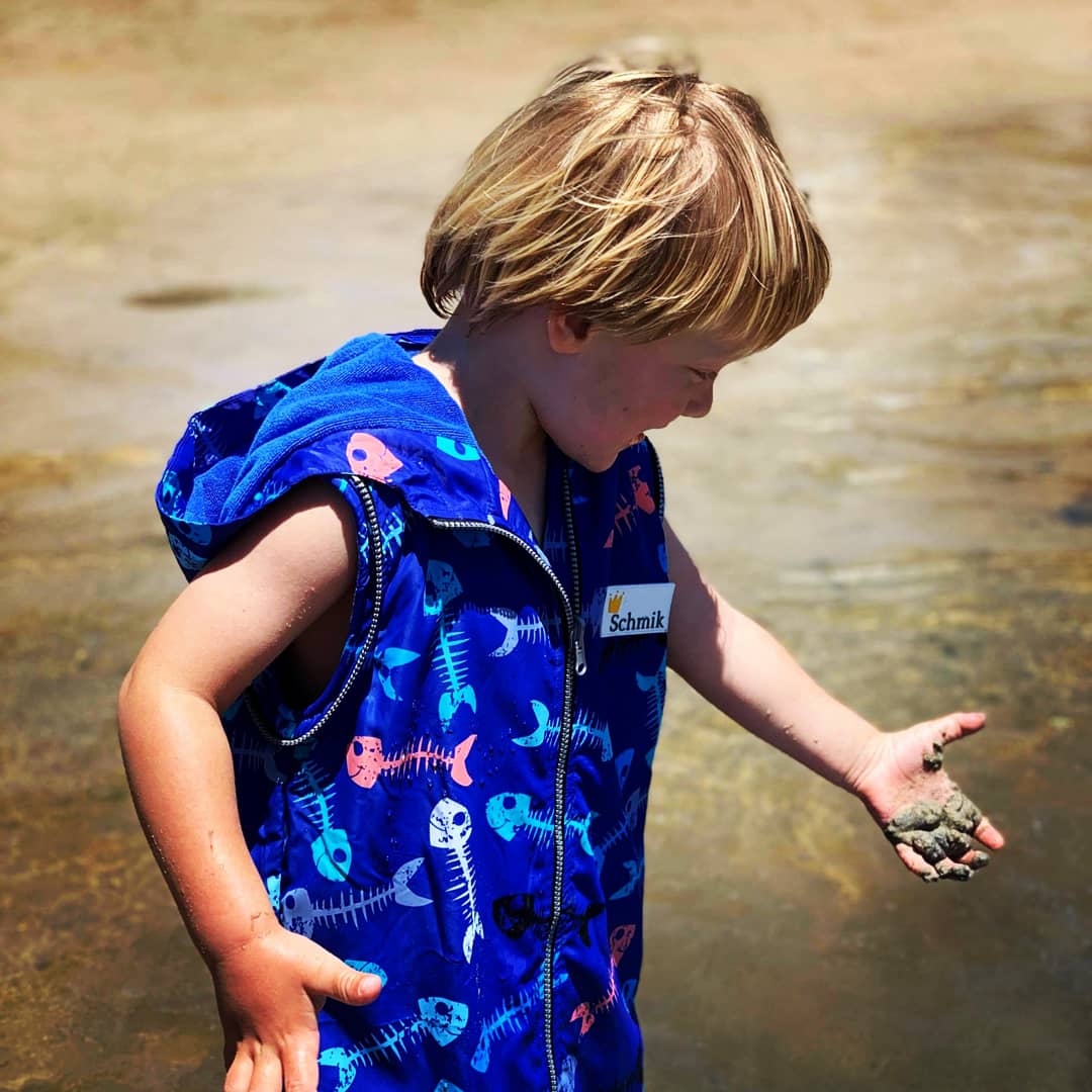 Boy wearing blue fishbone print swim parka, Swim parka comes with removeable arms and this picture the swim parka has the arms taken off it.