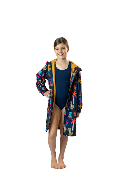 Schmik swim coat for kids and adults worn by girl. Beach robe keeps nippers and surfers, swimmers and beach goers warm and dry. No need for towels or hooted towels, Schmik swim parkas are the best swim parkas. 